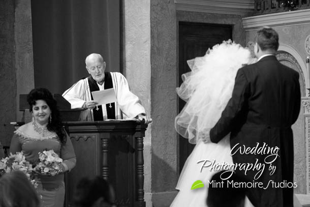 minister reading to bride and groom